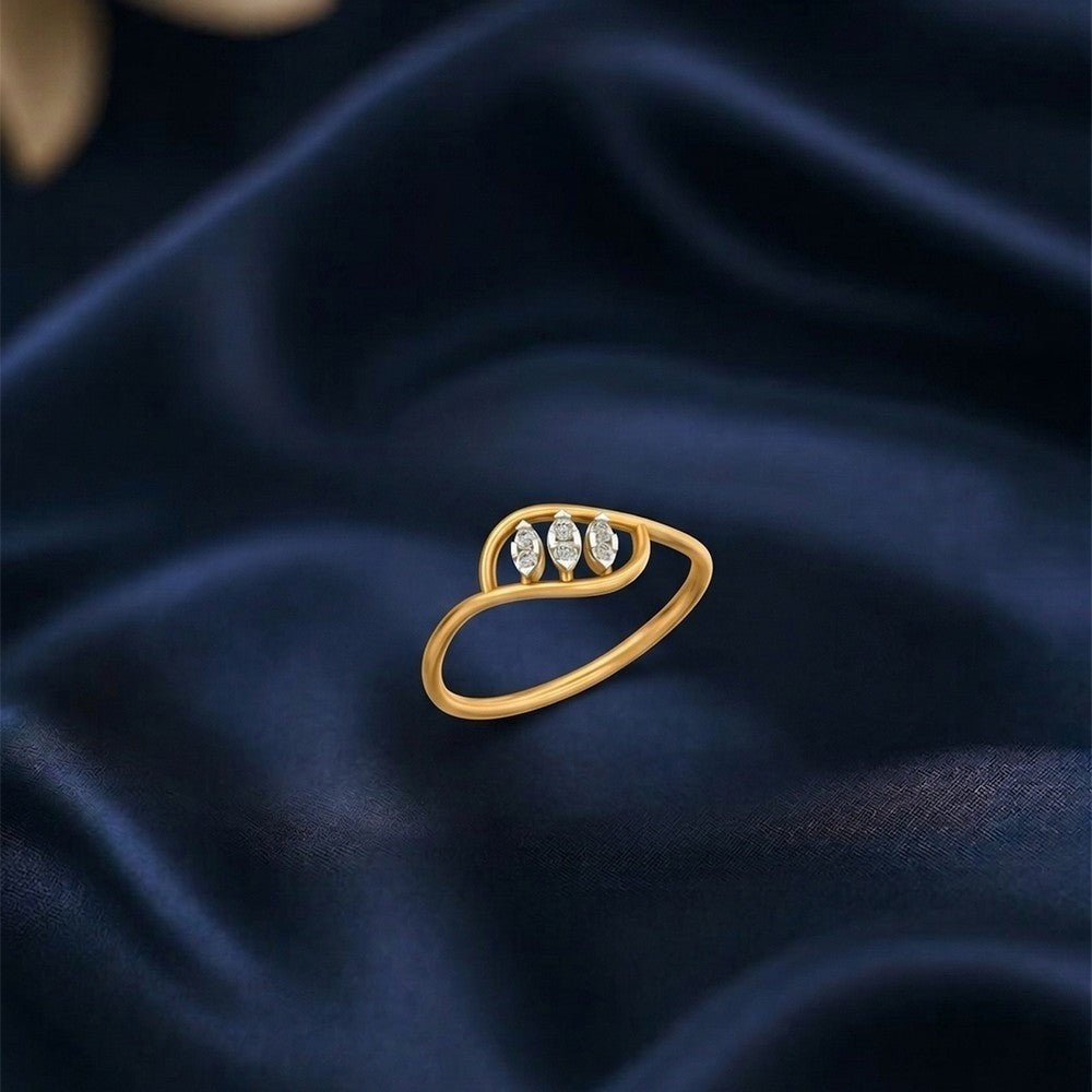 Gold and diamond ring on a blue surface.