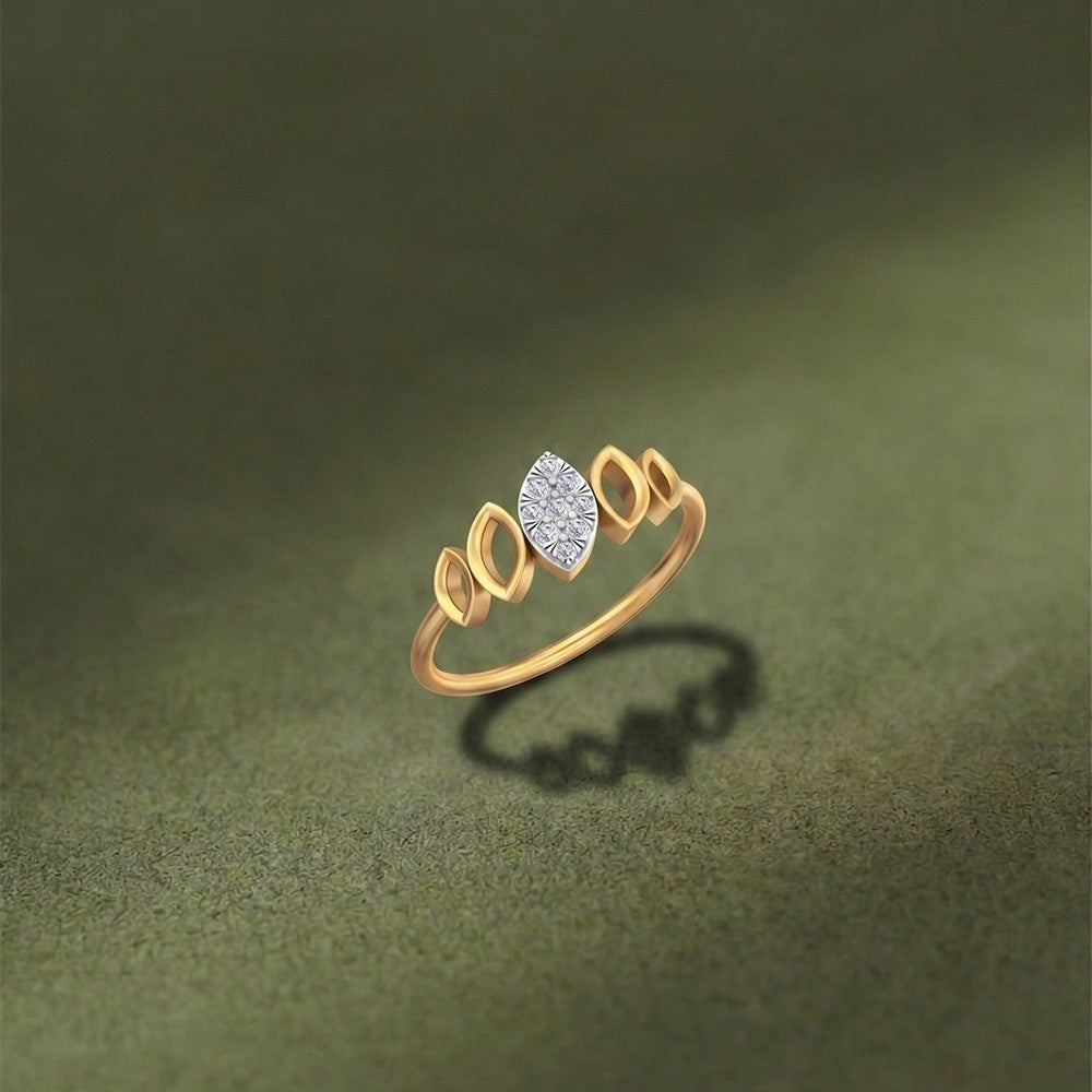 Gold ring with a diamond on a green textured background