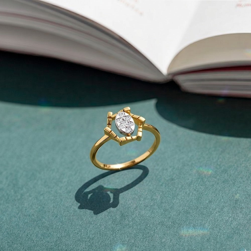 Gold and diamond with cluster setting on a teal surface.