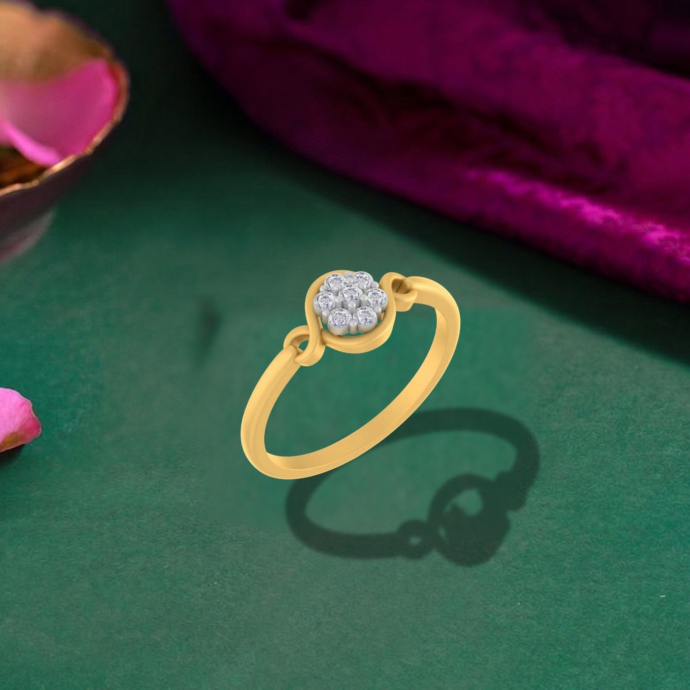 Gold ring with a diamond cluster on a green surface.