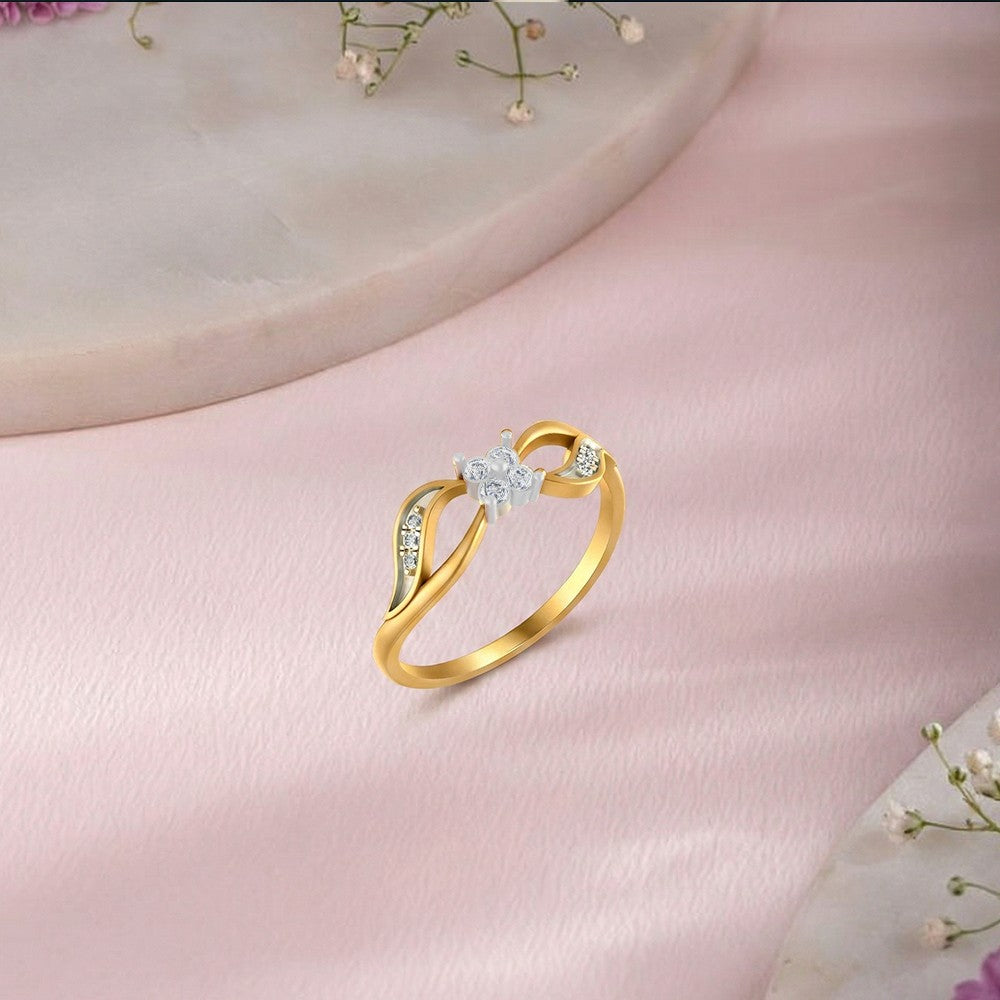Gold and diamond with center diamond setting on a pink surface.