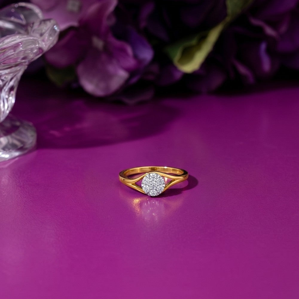 Gold and diamond with cluster setting on a purple surface.