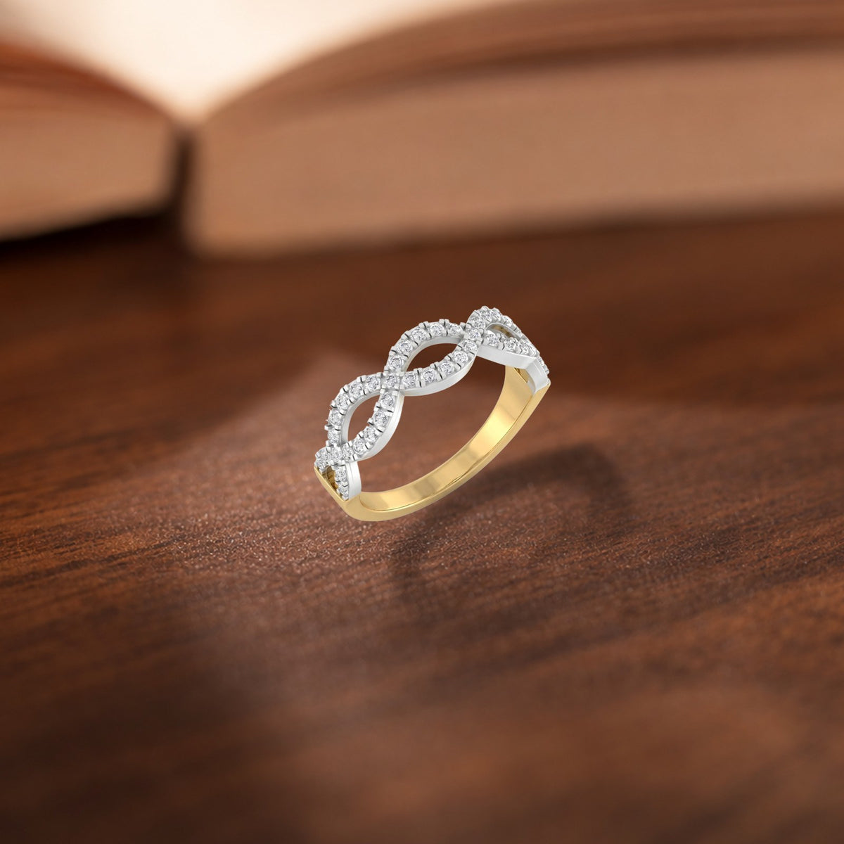 Gold and diamond half-eternity ring on a wooden surface.