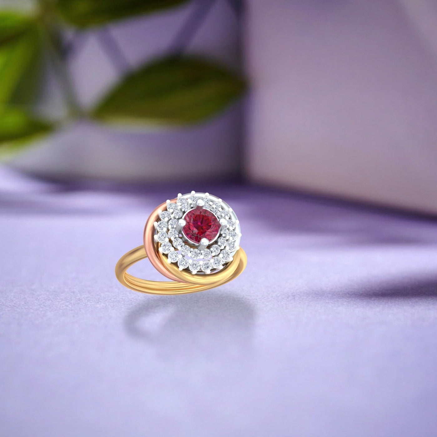 Gold and diamond featuring a central round red gemstone, resting on a purple surface.