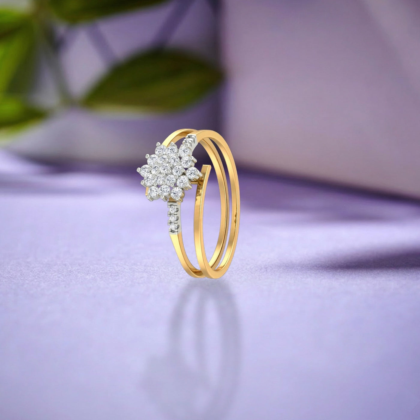 Gold ring with diamond design on a purple fabric background