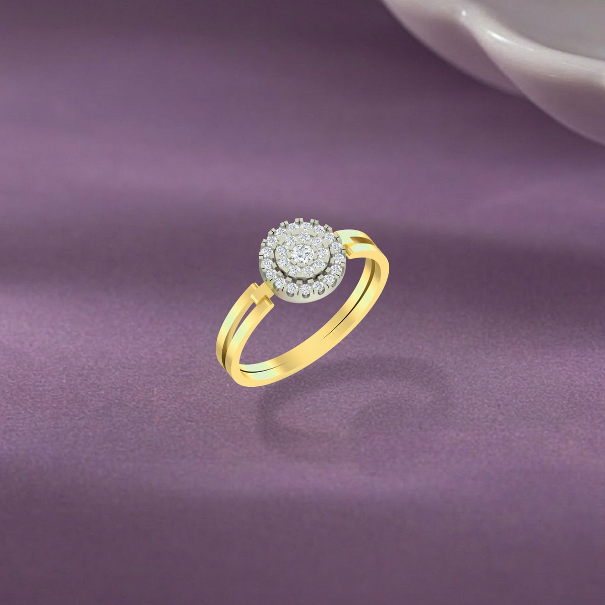 A gold ring with a round halo, displayed on a textured purple surface.