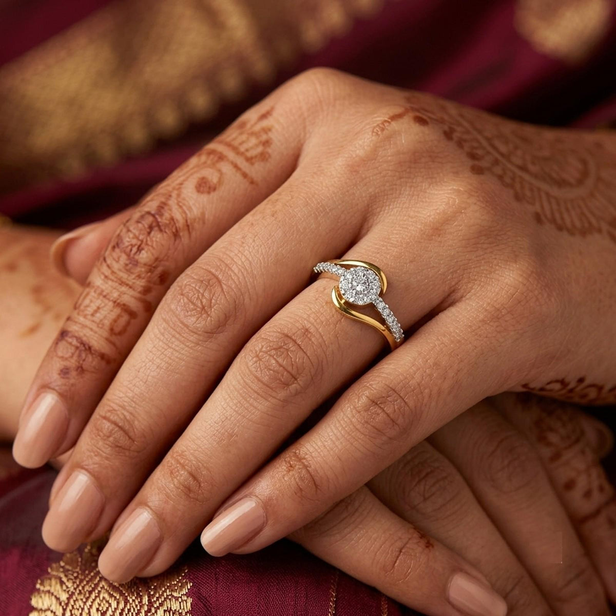 Gold ring with diamonds on a person's finger against a red background