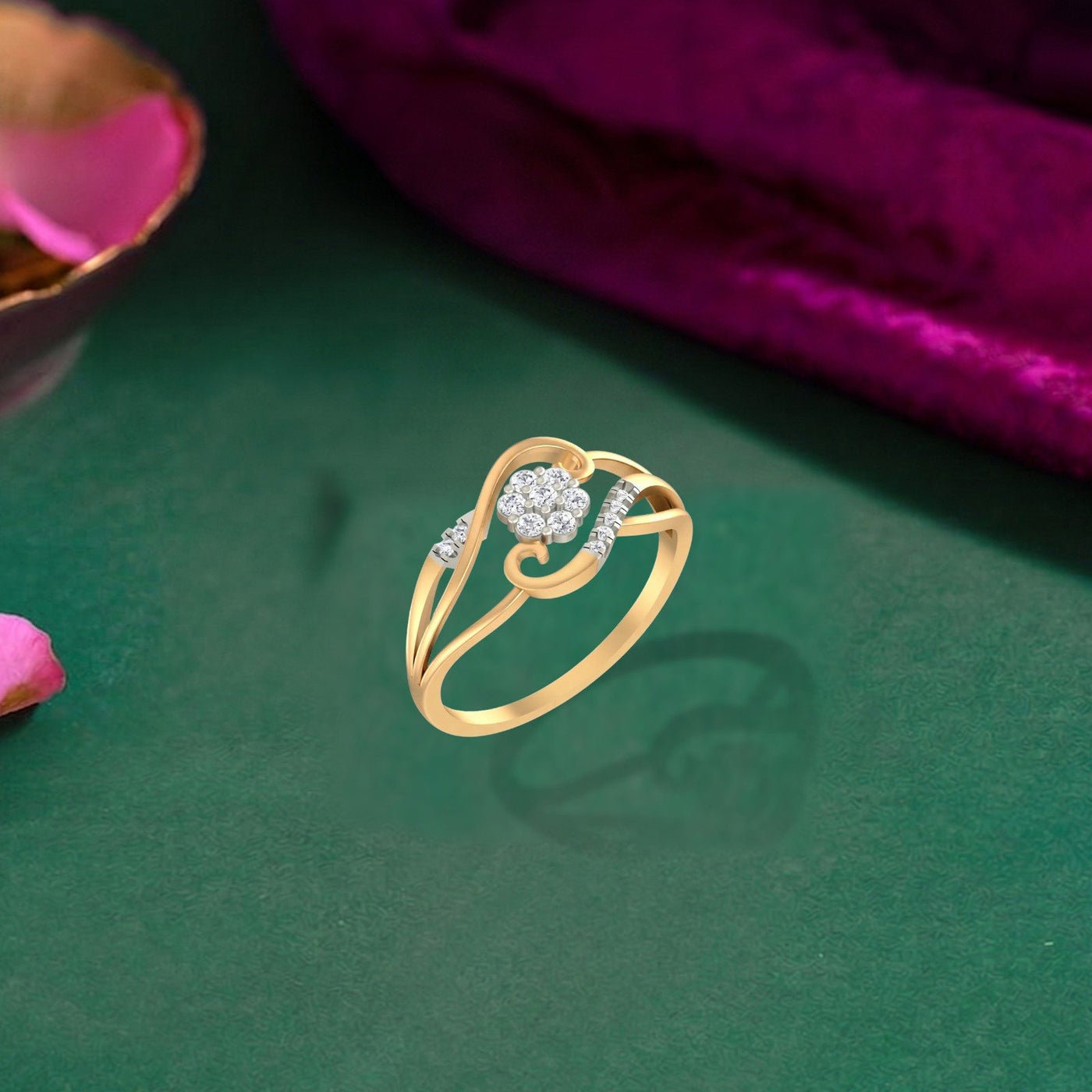 Gold and diamond with floral cluster setting on a green surface.