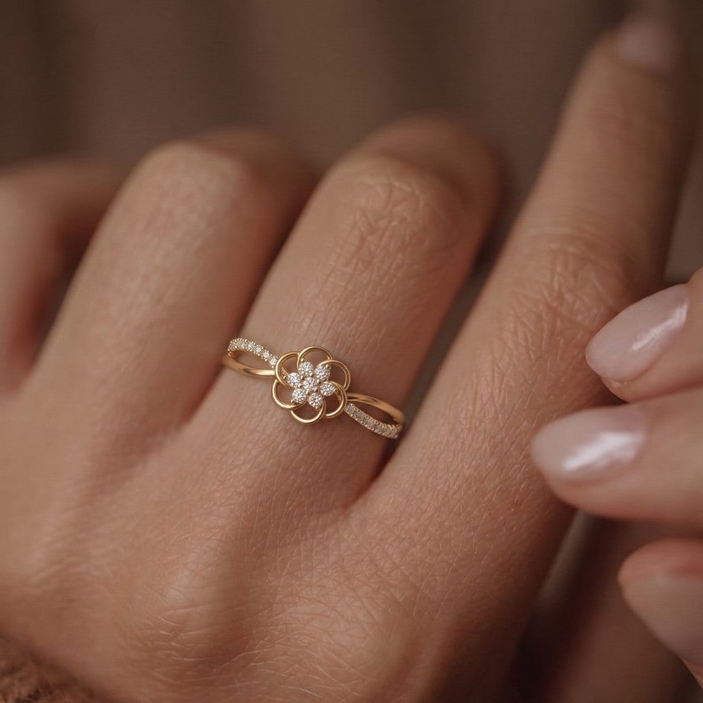 Close-up shotd of a gold and diamond with floral design ring.