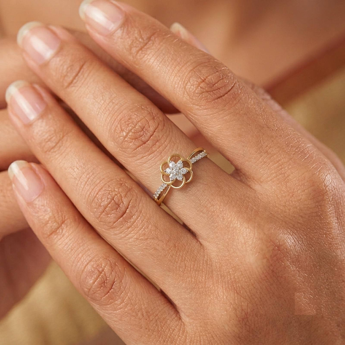 Close-up shot of a gold and diamond with floral design ring.