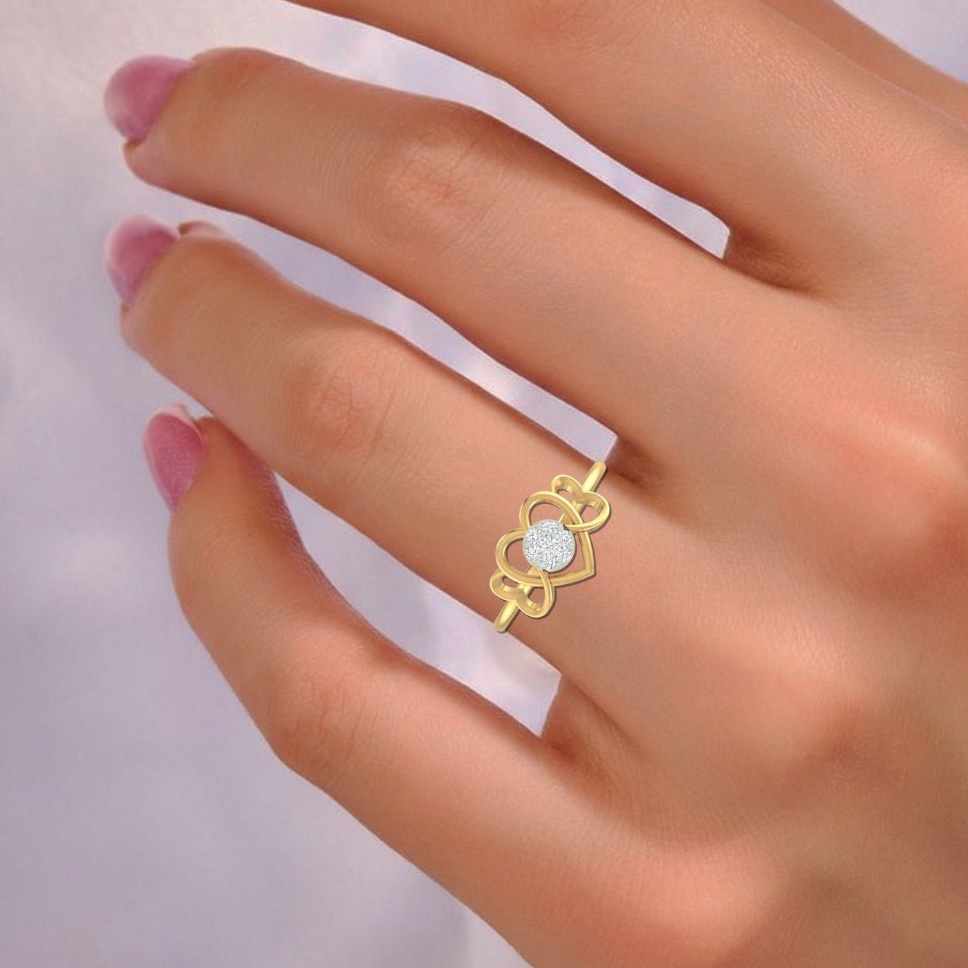 Gold ring with a diamond on a hand against a light background