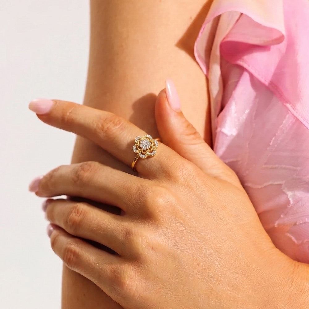 Close-up shot of a gold and diamond with floral design ring.