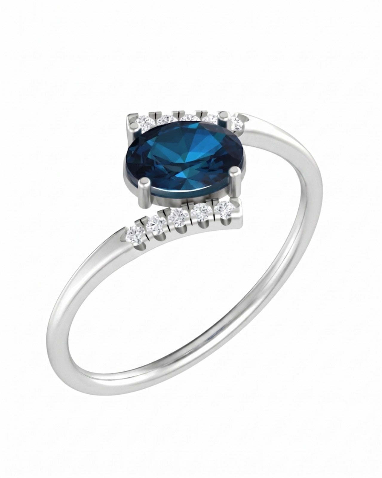 A white gold ring with a central oval-cut sapphire gemstone, shown on a plain white background.