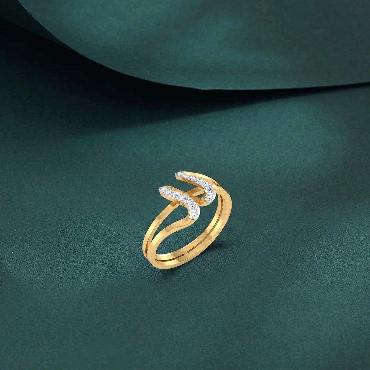 Gold ring with a double-band design, shown on a teal surface.