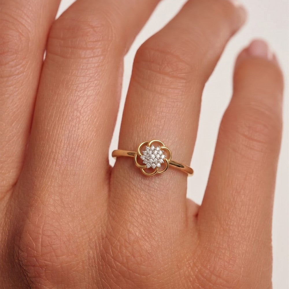 Close-up shot of a gold and diamond with floral cluster setting ring.