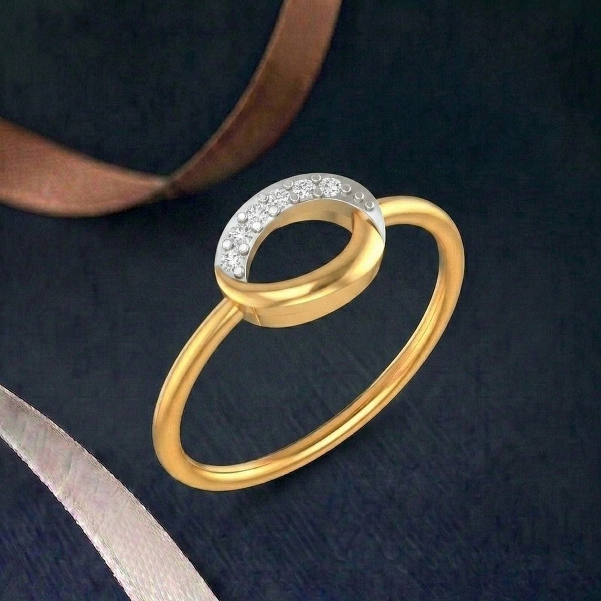 Gold ring with a small diamond on a teal surface.
