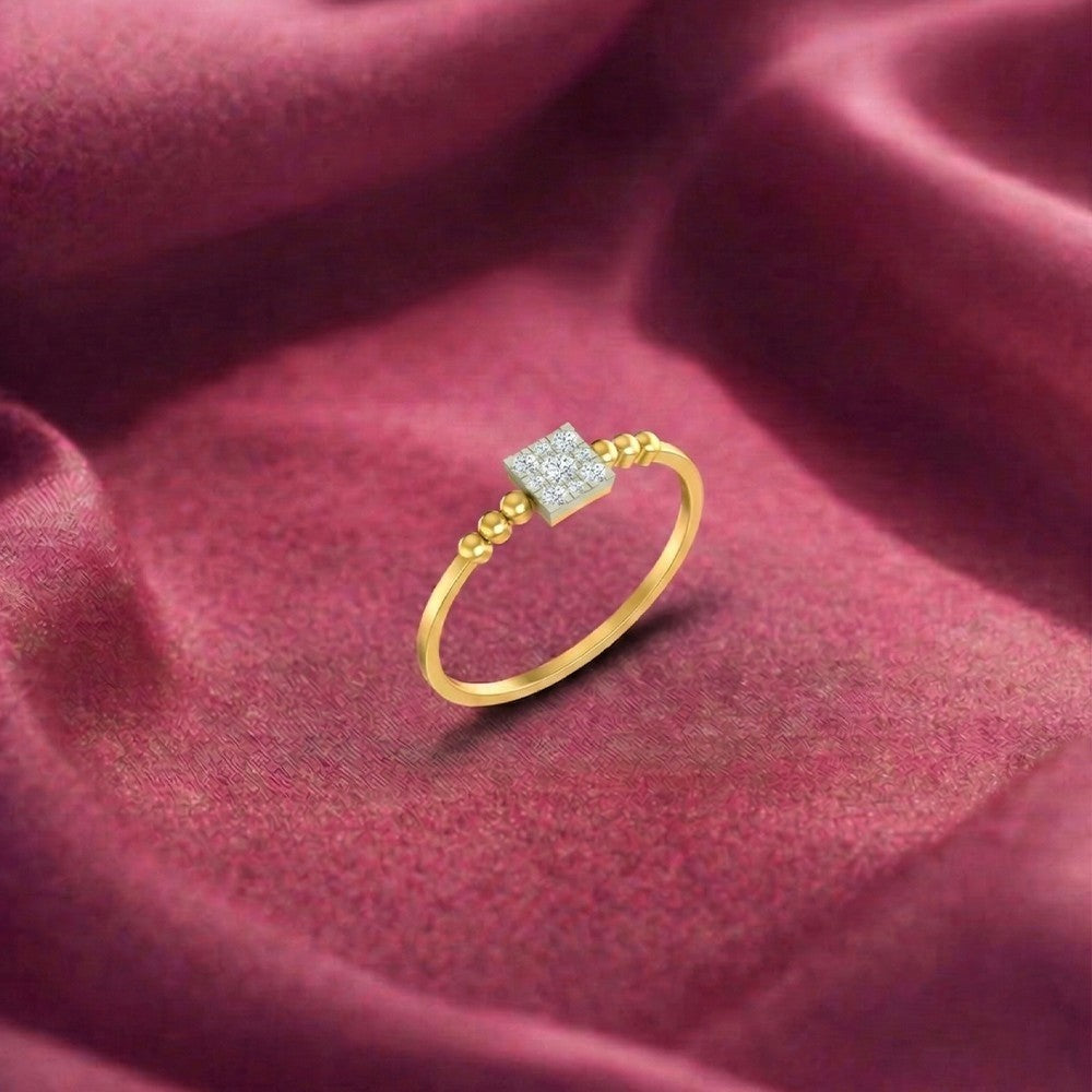 Gold ring with a diamond on a red fabric background