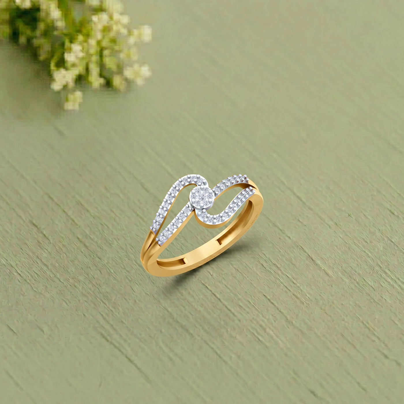 Gold and diamond with cluster setting, on a saga green surface.