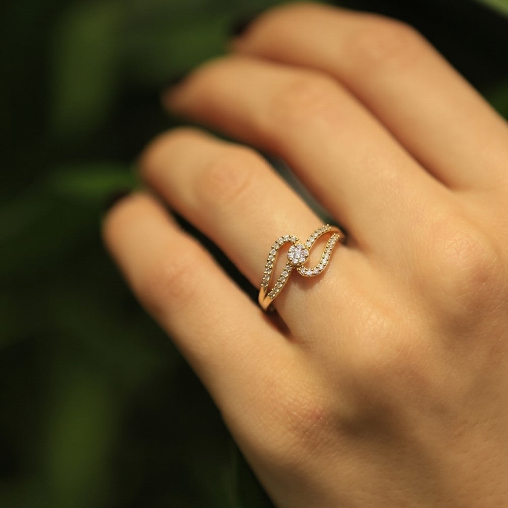 Women wearing a gold and diamond with cluster setting ring.