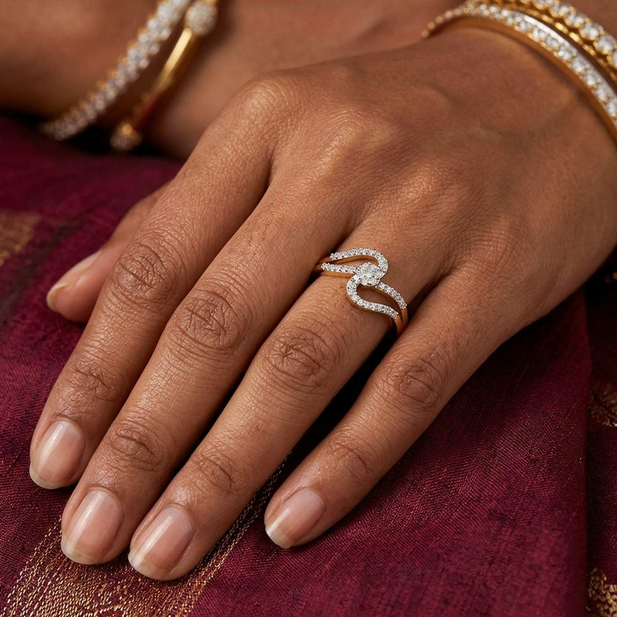 Women wearing a gold and diamond with cluster setting ring.