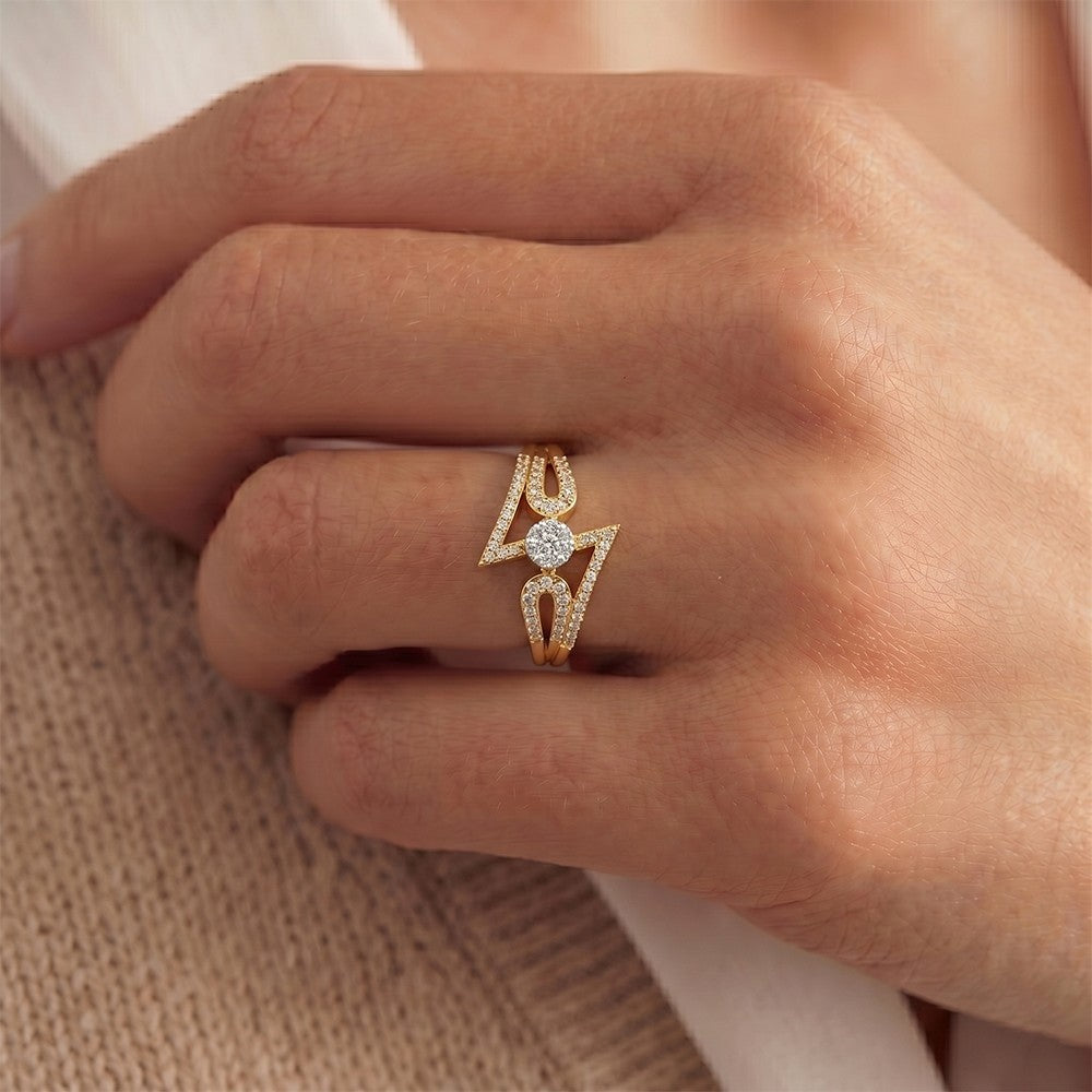 Close-up of a hand wearing a rose gold ring with a diamond on a neutral background