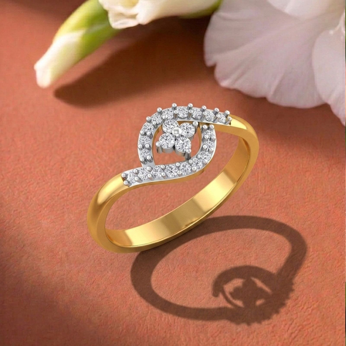 A gold ring and diamond floral design set, displayed on a textured brown surface.