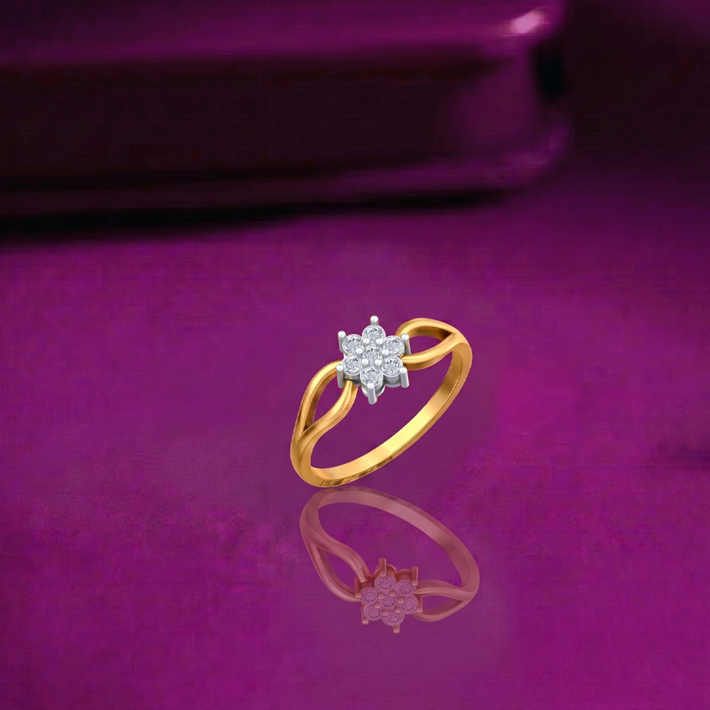 Gold and diamond with floral cluster on a reflective surface.