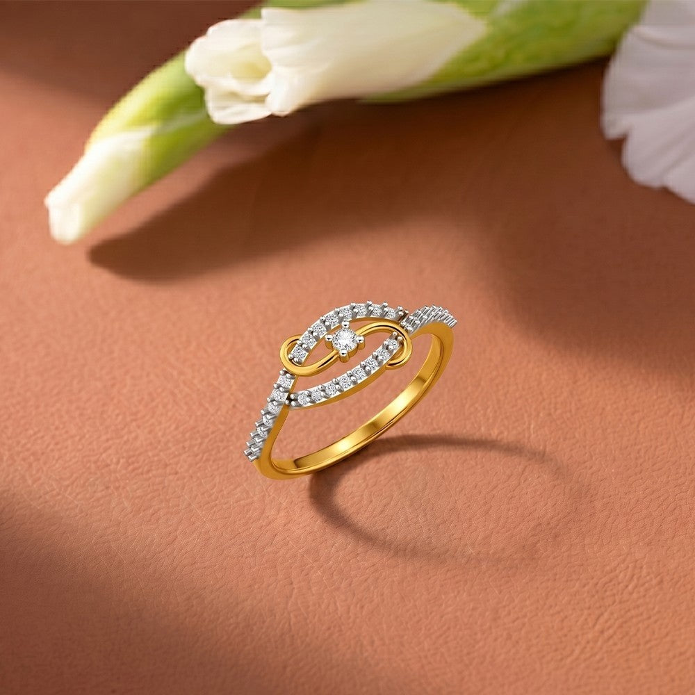 Gold and diamond women's ring on a orange surface.