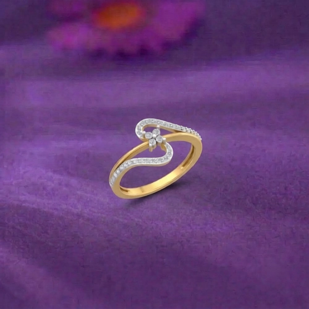A gold and diamond ring with a cluster design, resting on a purple textured fabric background.