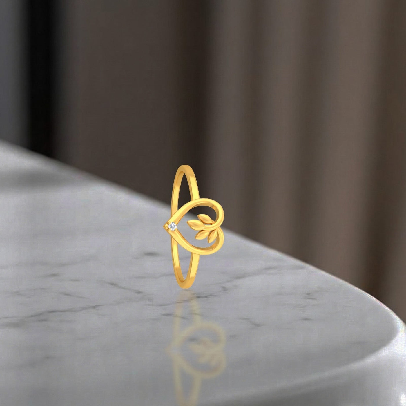 Gold and diamond with heart-shaped on a reflective grey surface.