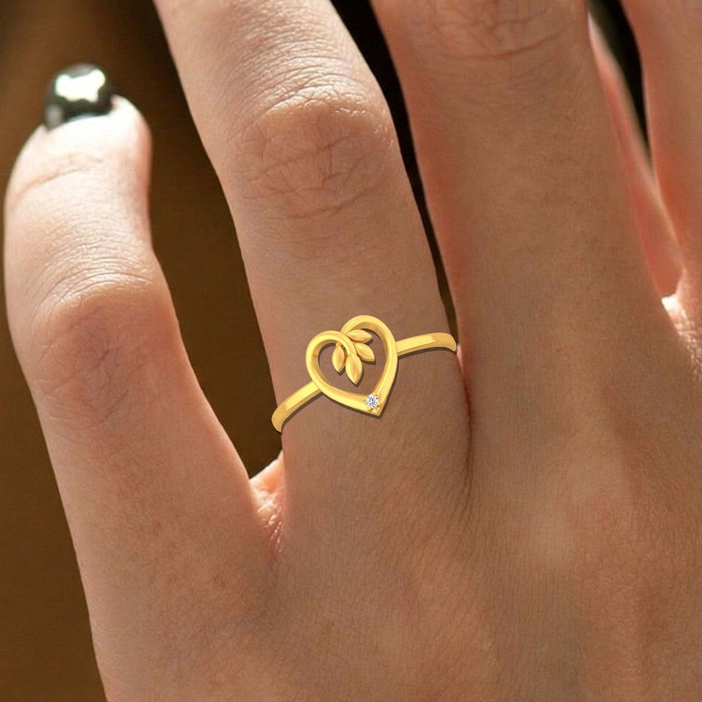 Gold and diamond with heart-shaped on a person's finger.