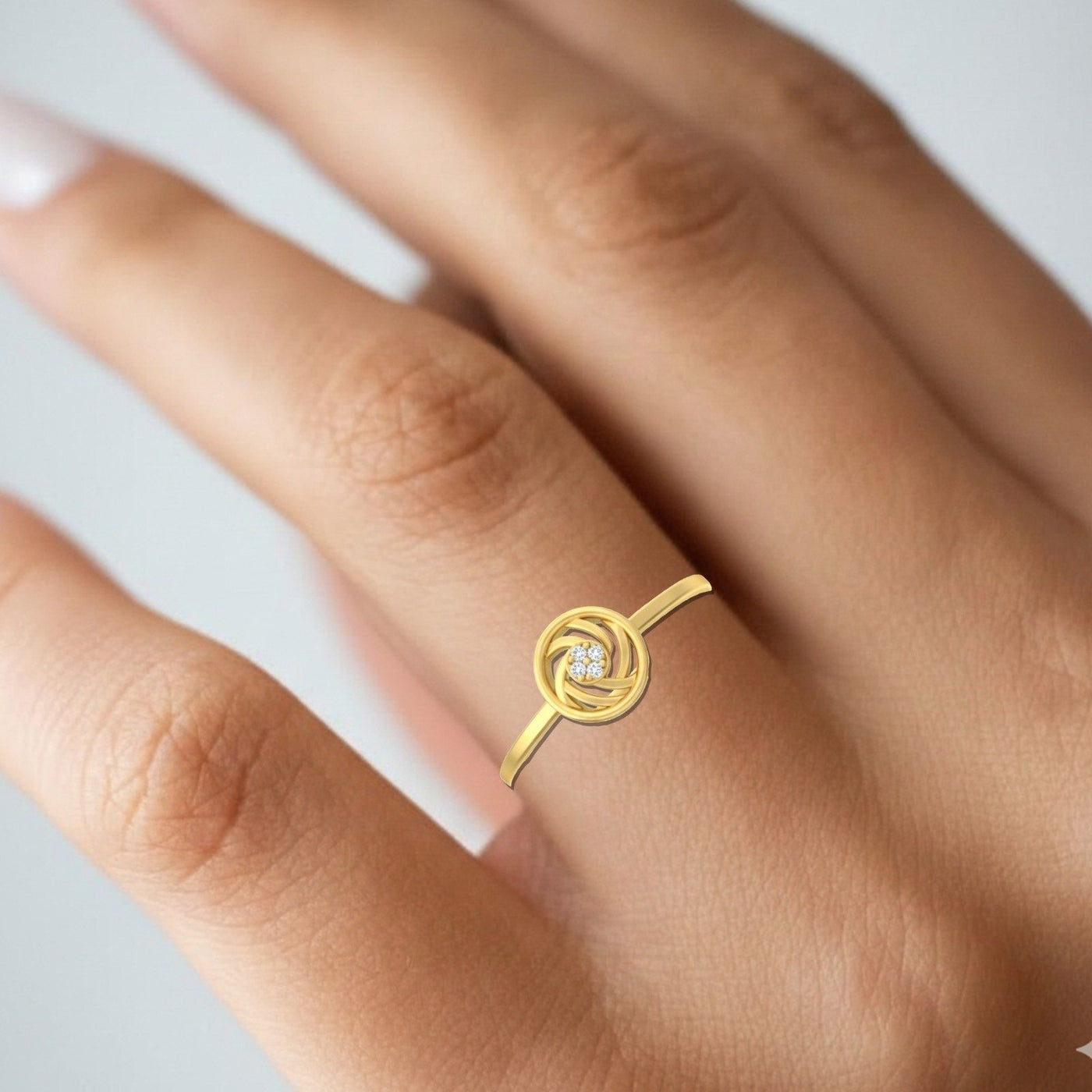 Gold and diamond with round-shaped on a person's finger.
