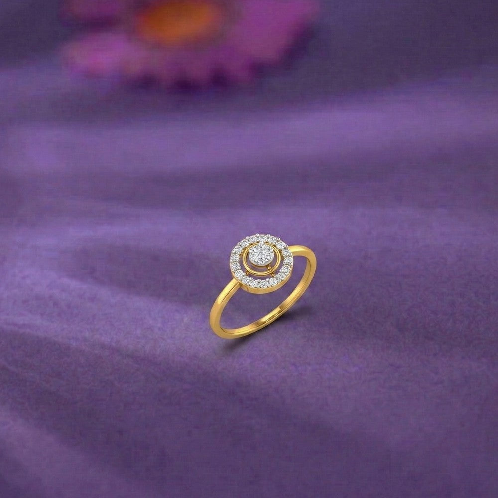 Gold and diamond with halo cluster setting on a purple surface.