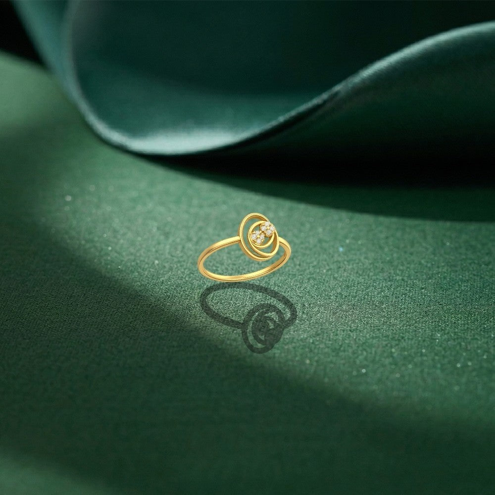 Gold and diamond with round-shaped on a green surface.