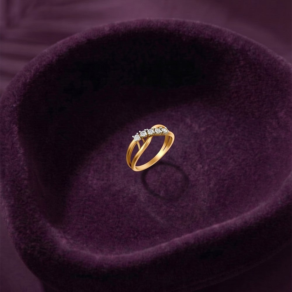 Gold and diamond ring, shown on a purple texture surface.