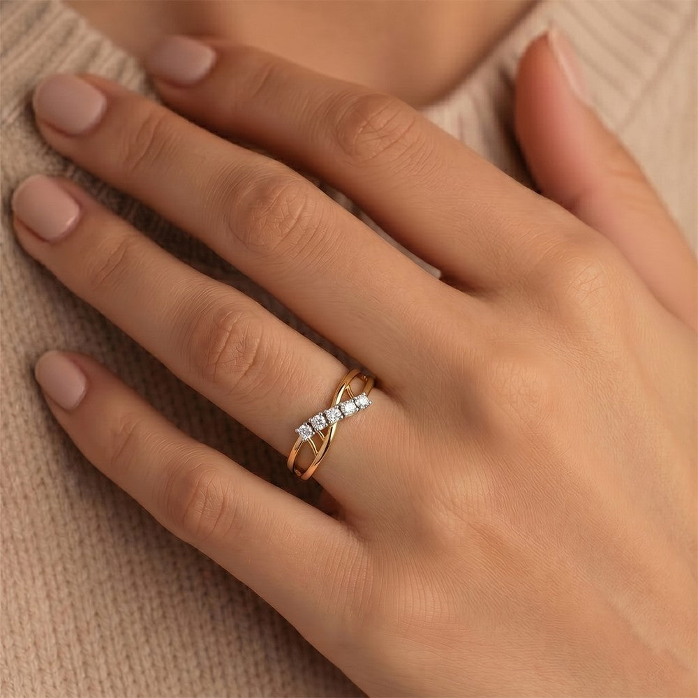 Hand wearing a gold ring with diamonds on a beige fabric background