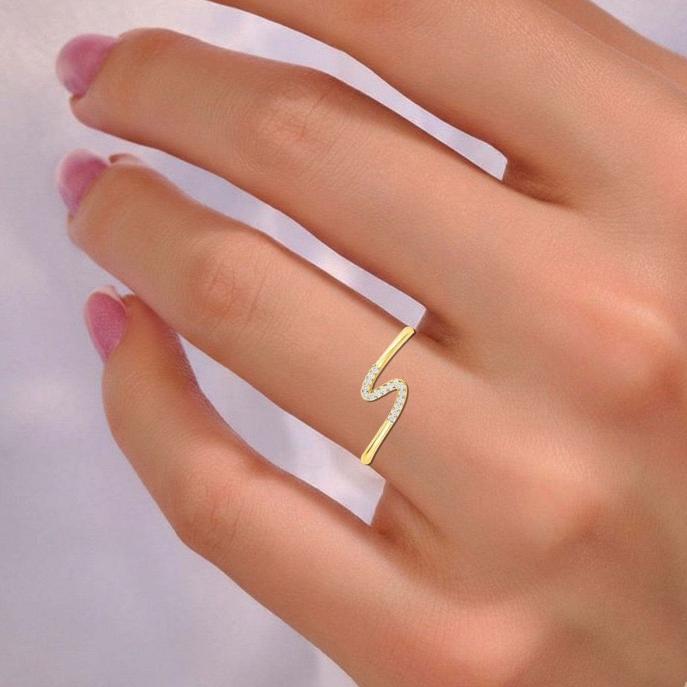 Close-up shot of a gold and diamond half-eternity ring