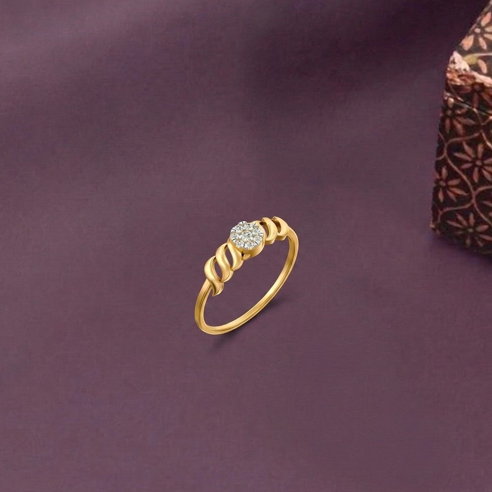 Gold and diamond with cluster setting on a purple surface.