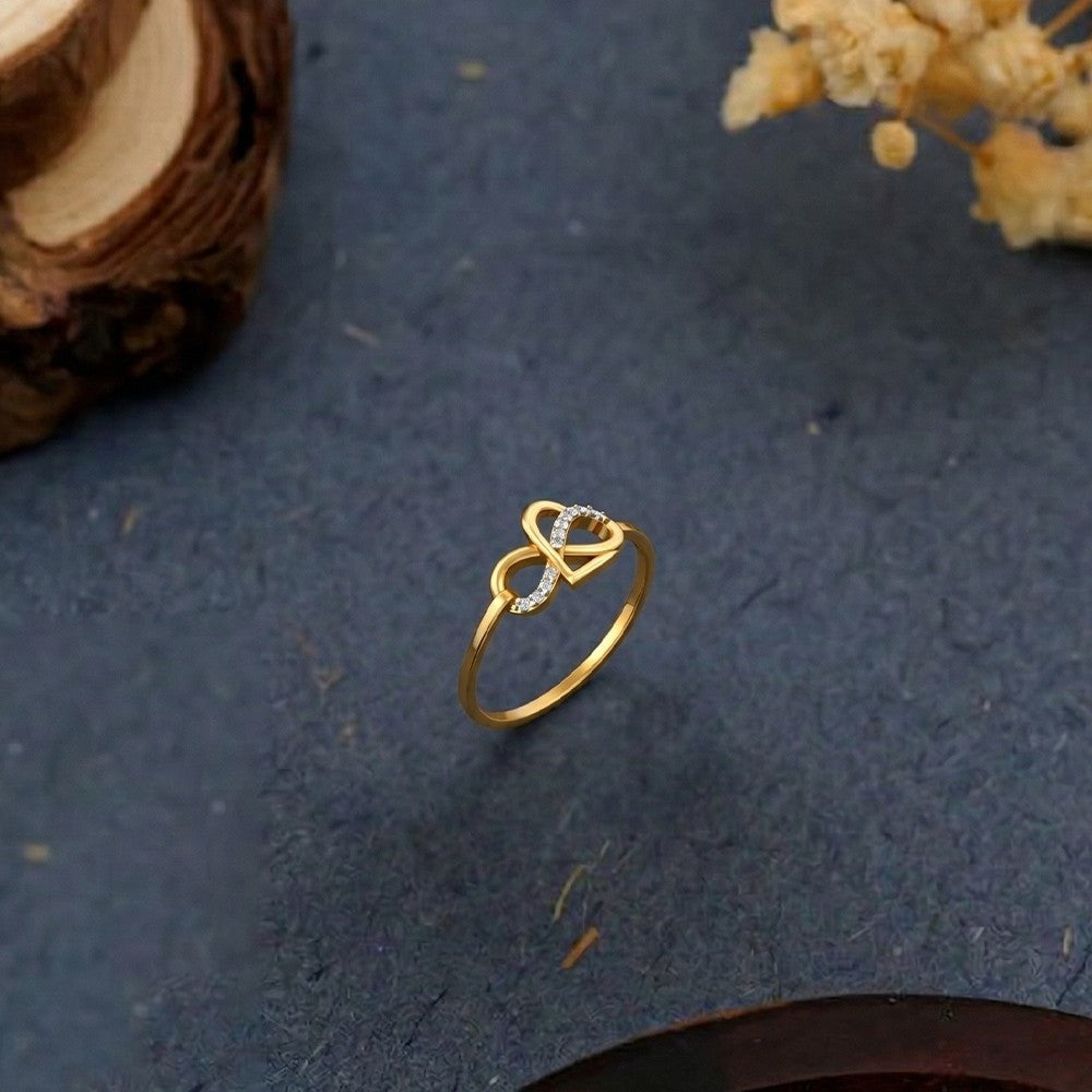 Gold and diamond with infinity design on a grey surface.