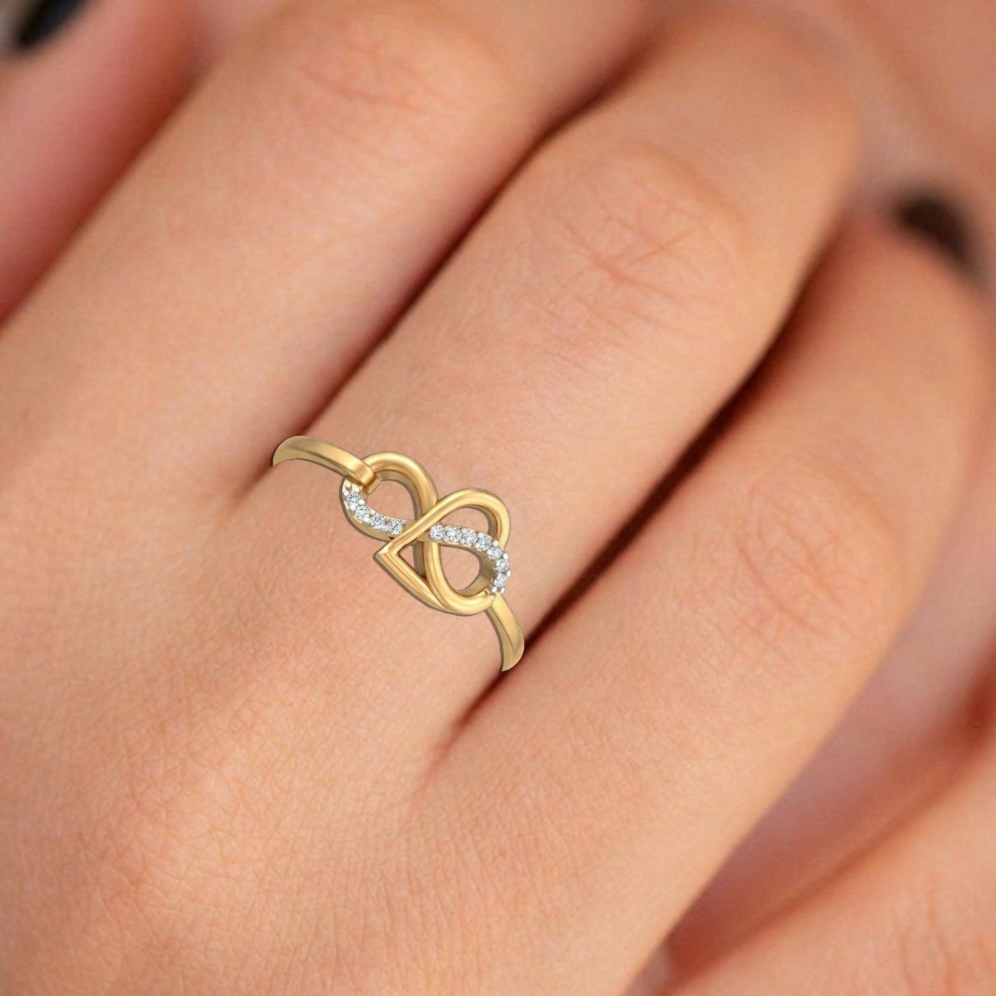 Close-up shot of a gold and diamond with infinity design ring.