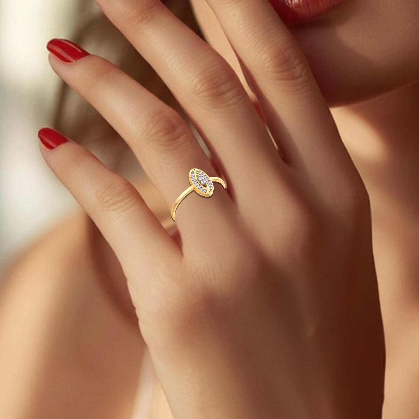 Close-up shot of a gold and diamond with oval-shaped ring.