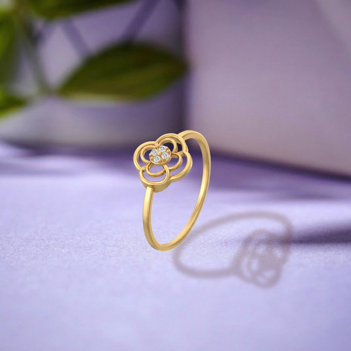 Gold and diamond with floral-design on a purple surface.