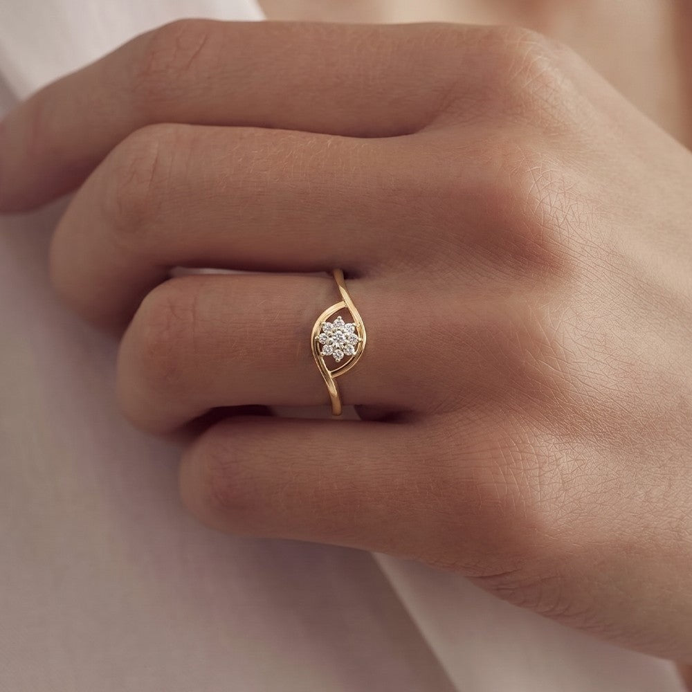 Close-up shot of a gold and diamond with floral cluster setting ring.