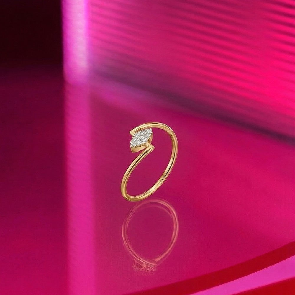 Gold and diamond with cluster setting on a pink reflective surface.