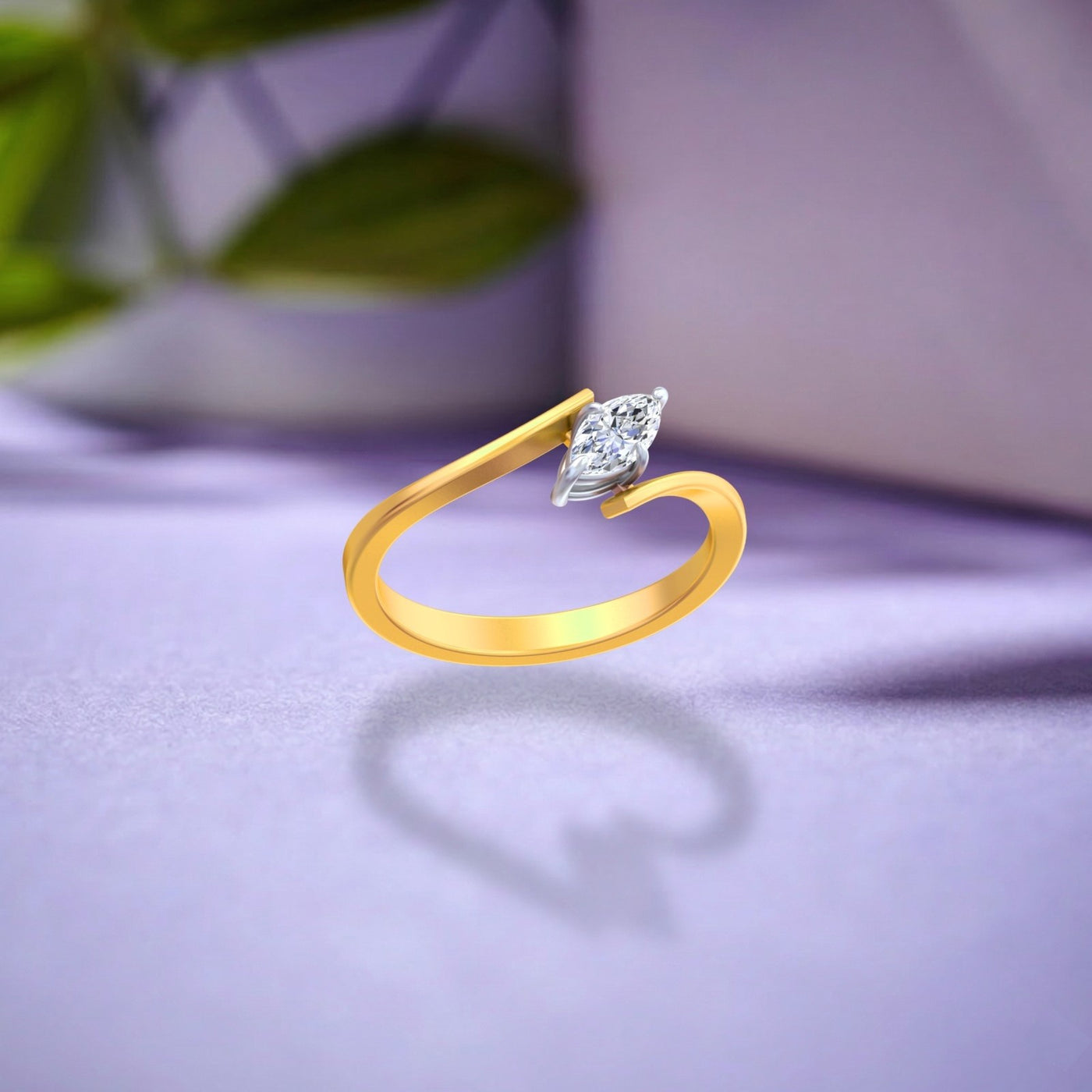 A gold ring with a marquise-cut diamond, displayed on a soft lavender surface with a blurred background.