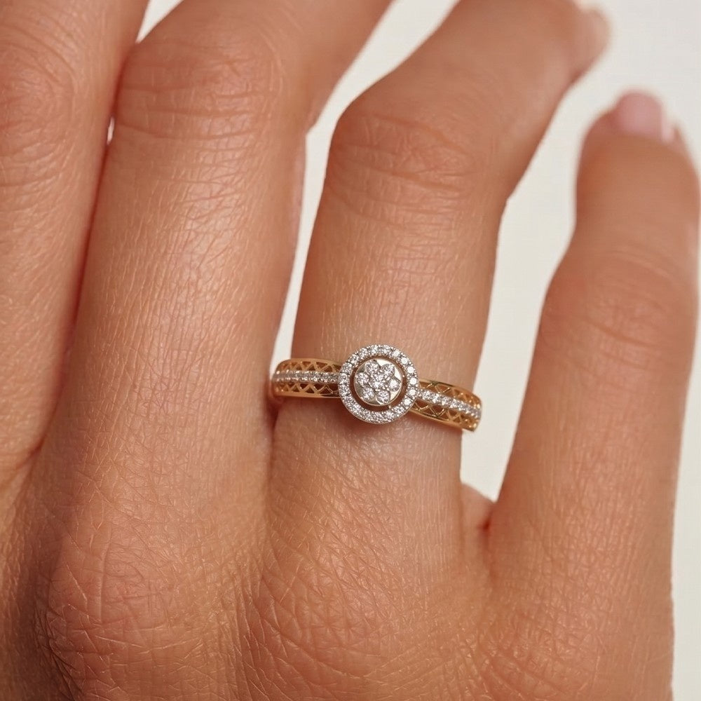 Rose gold ring with diamond on a person's finger against a white background