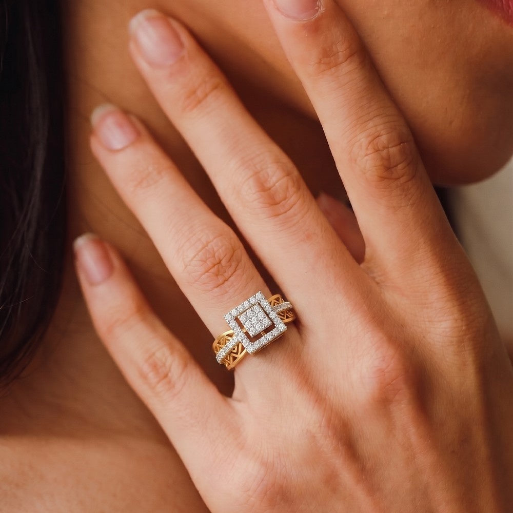 Close-up of a hand wearing a diamond ring with a soft focus background