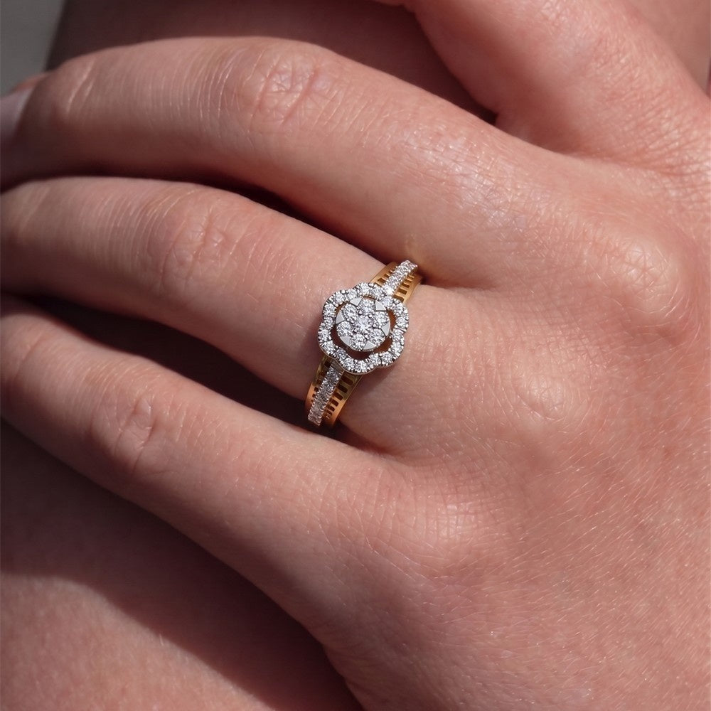 A close-up of a hand wearing a gold and diamond ring.