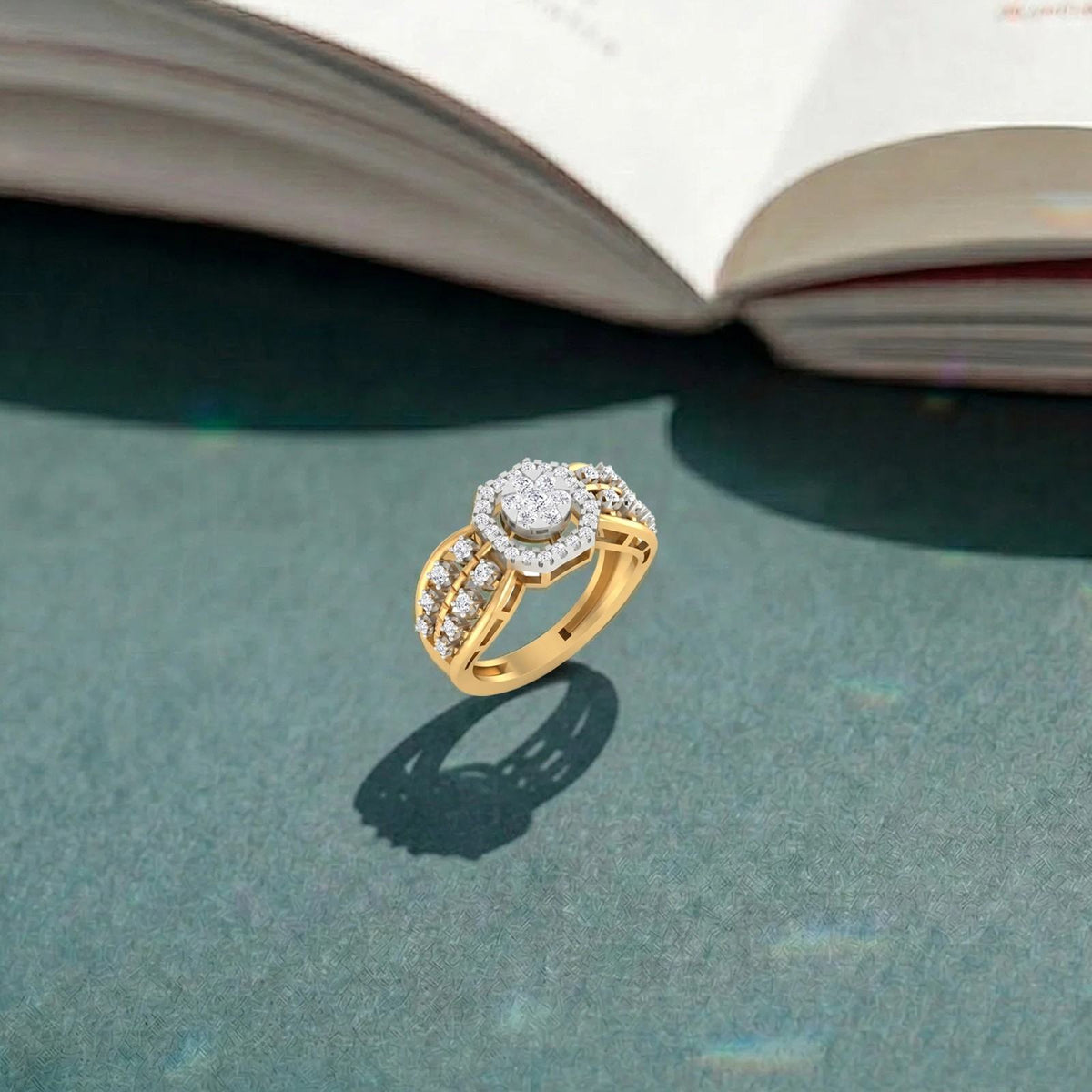 Gold ring with diamonds on a textured surface with an open book in the background.