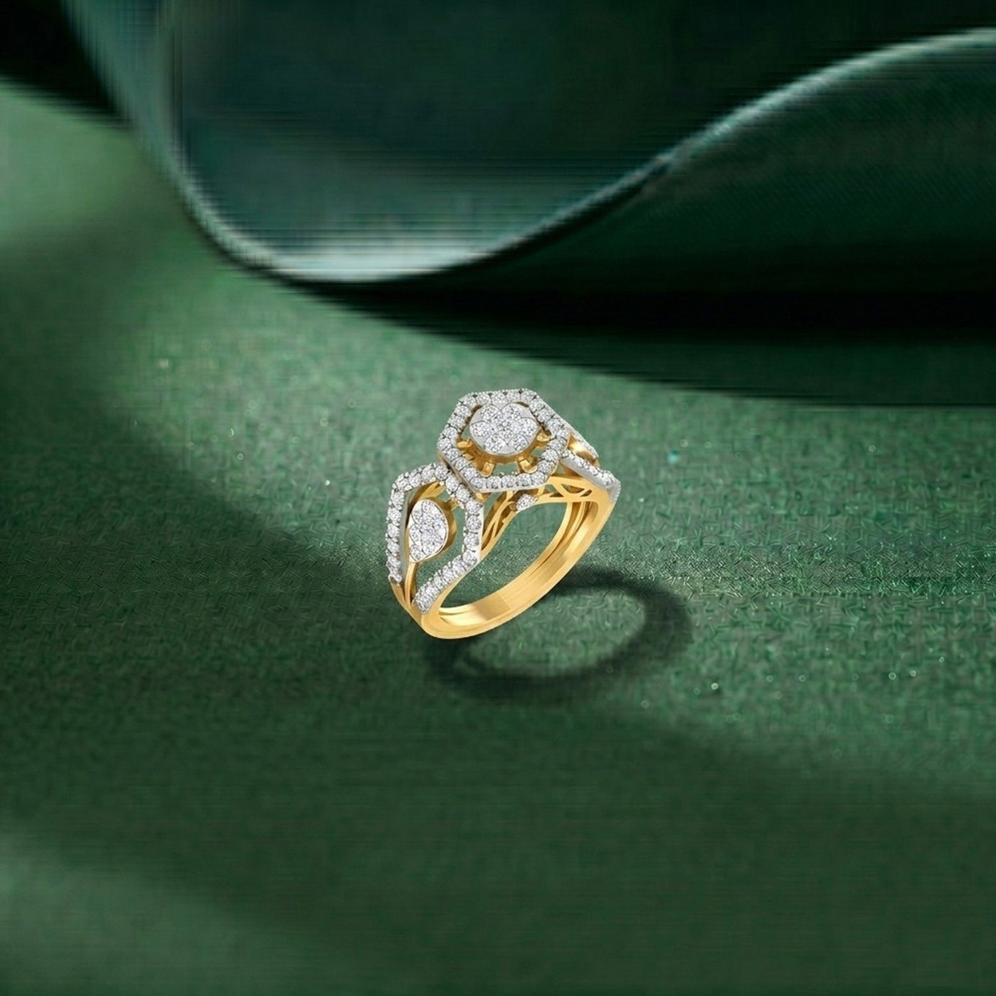Gold and diamond ring on a green surface